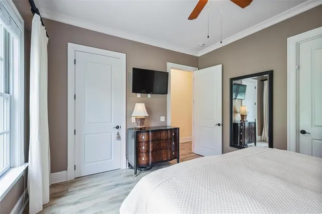 a bedroom with a bed and wooden floor