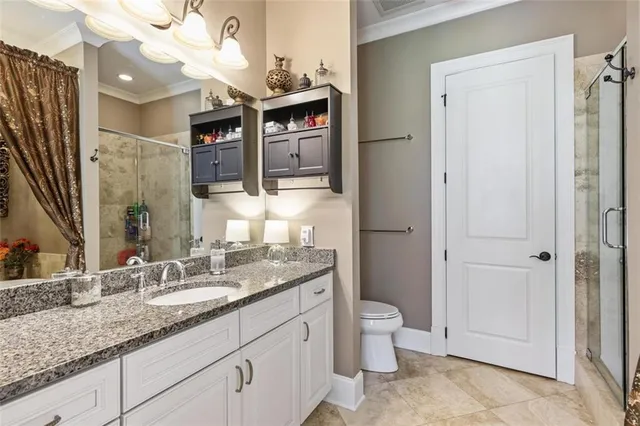 a spacious bathroom with a granite countertop sink and a mirror