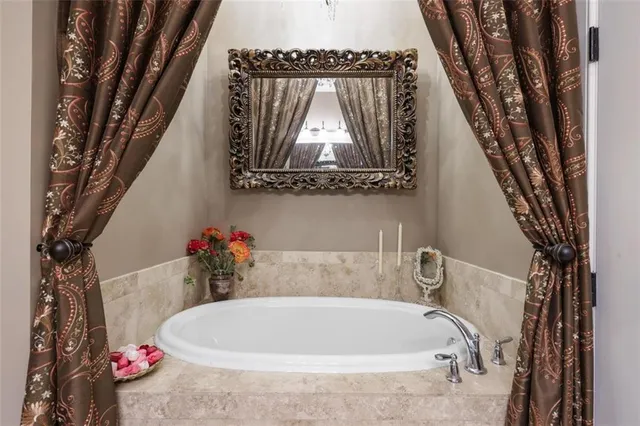 a bath tub sitting next to a white toilet