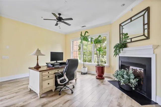 a view of a workspace with furniture and a fireplace