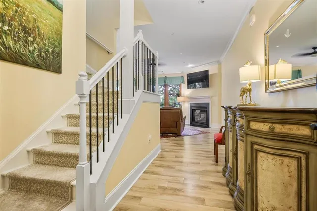 a view of a livingroom with wooden floor and a fireplace