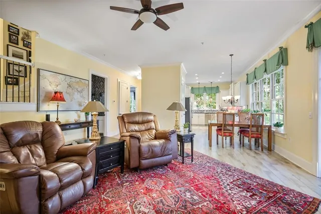 a living room with furniture and a dining table