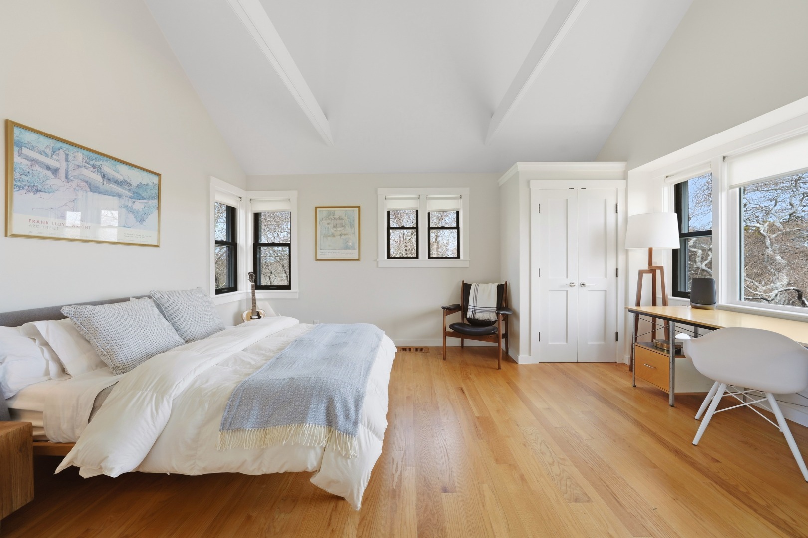 247 Polpis Road Nantucket, MA 02554 - Photo 23 of 52 a spacious bedroom with a bed a table and chair