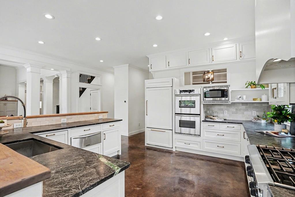 3923 Ranch Estates Circle Plano, TX 75074 - Photo 10 of 32 a kitchen with stainless steel appliances kitchen island granite countertop a stove and a sink