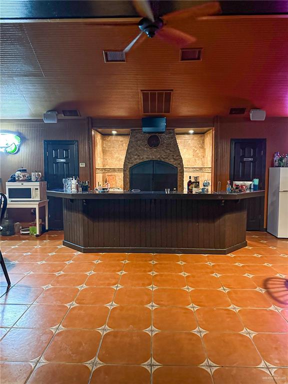 0 West Arroyo City Boulevard Rio Hondo, TX 78583 - Photo 25 of 29 a view of a kitchen with kitchen island a sink a counter top space and a fireplace