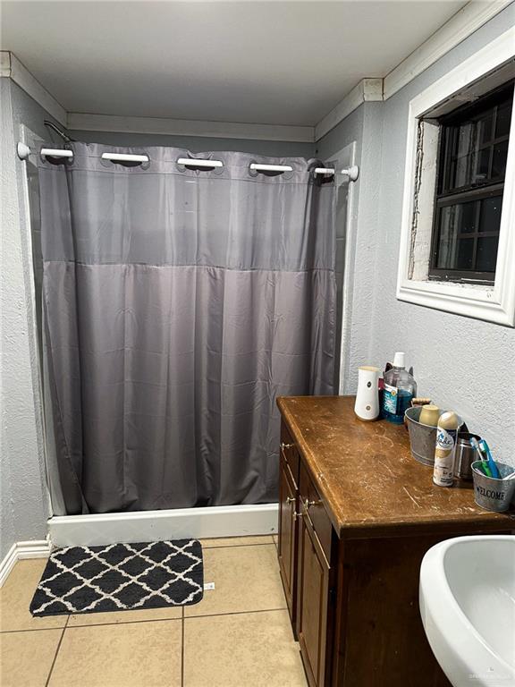 0 West Arroyo City Boulevard Rio Hondo, TX 78583 - Photo 29 of 29 a bathroom with a granite countertop sink and a washing machine