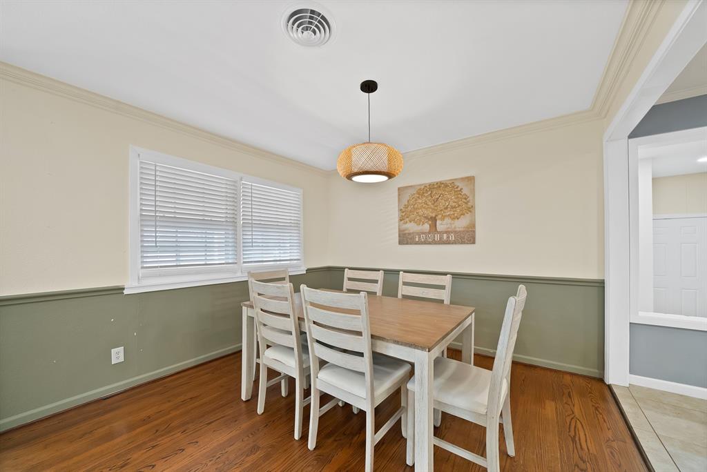 5705 Blue Ridge Drive Fort Worth, TX 76112 - Photo 18 of 40 a view of a dining room with furniture wooden floor and chandelier