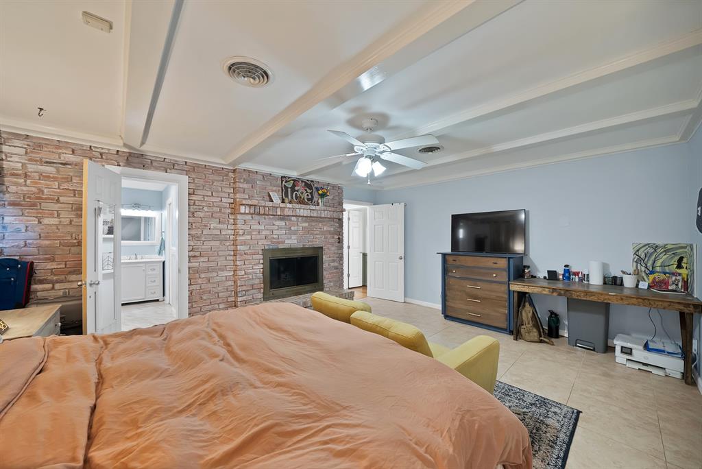 5705 Blue Ridge Drive Fort Worth, TX 76112 - Photo 26 of 40 a bedroom with a bed and a flat screen tv