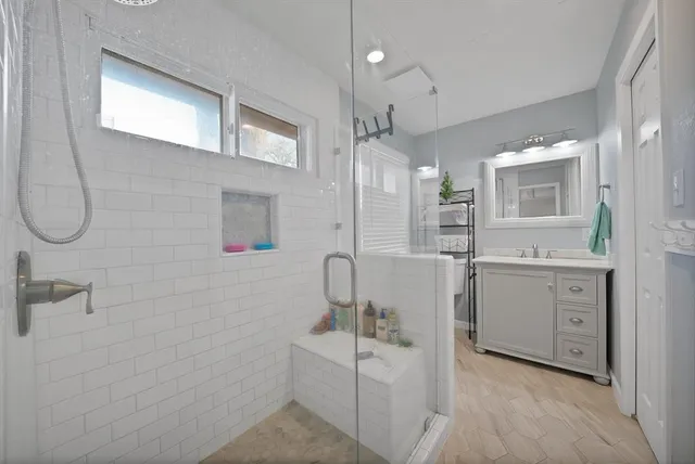 a bathroom with a sink a toilet and shower