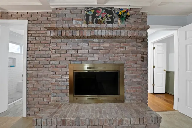 a spacious bedroom with a bed a fireplace and a couch