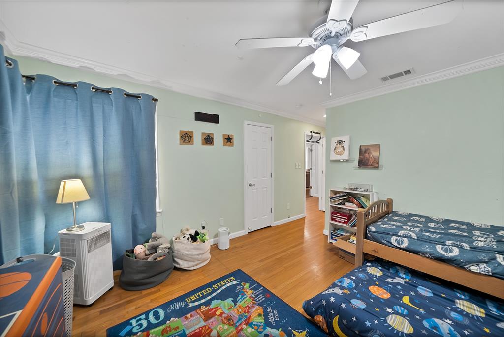 5705 Blue Ridge Drive Fort Worth, TX 76112 - Photo 33 of 40 a bedroom with a bed and wooden floor