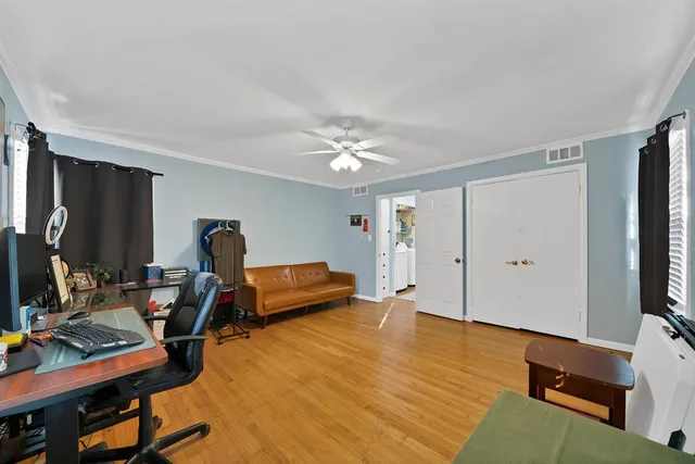 a bathroom with a granite countertop sink a toilet a mirror and bathtub