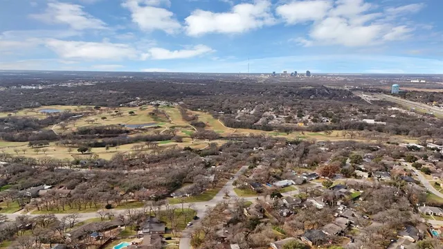 an aerial view of residential building and trees around