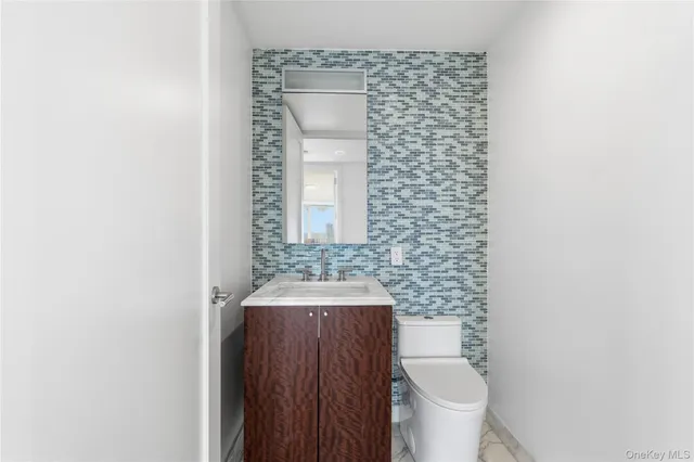 a view of a bedroom with wooden floor and windows