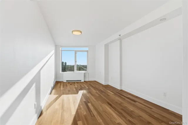 a view of a big room with wooden floor and staircase