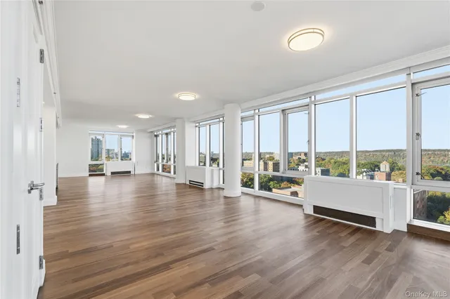a view of an empty room with large windows