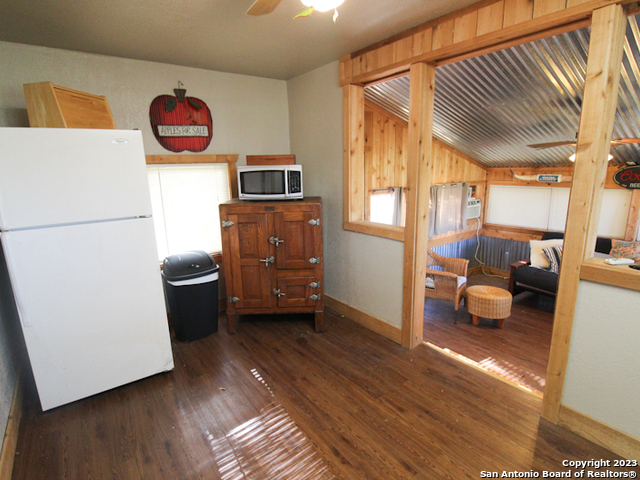 955 Faurie Road, Unit CEDAR CABIN Lakehills, TX 78063 - Photo 9 of 21 a kitchen with a refrigerator and a stove