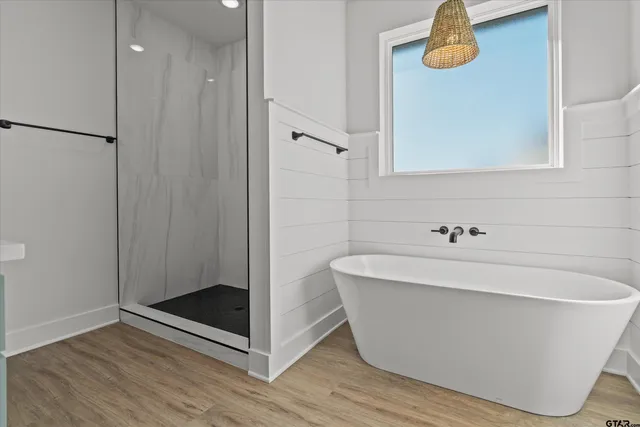 a white bath tub sitting next to a bathroom sink