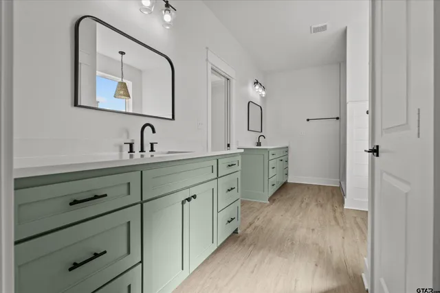 a bathroom with a double vanity sink and mirror