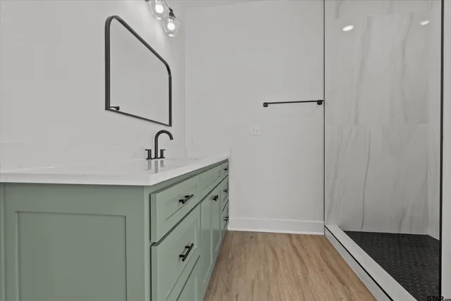 a bathroom with a double vanity sink and mirror