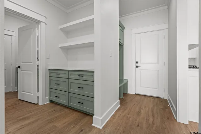 a view of walk in closet with wooden floor