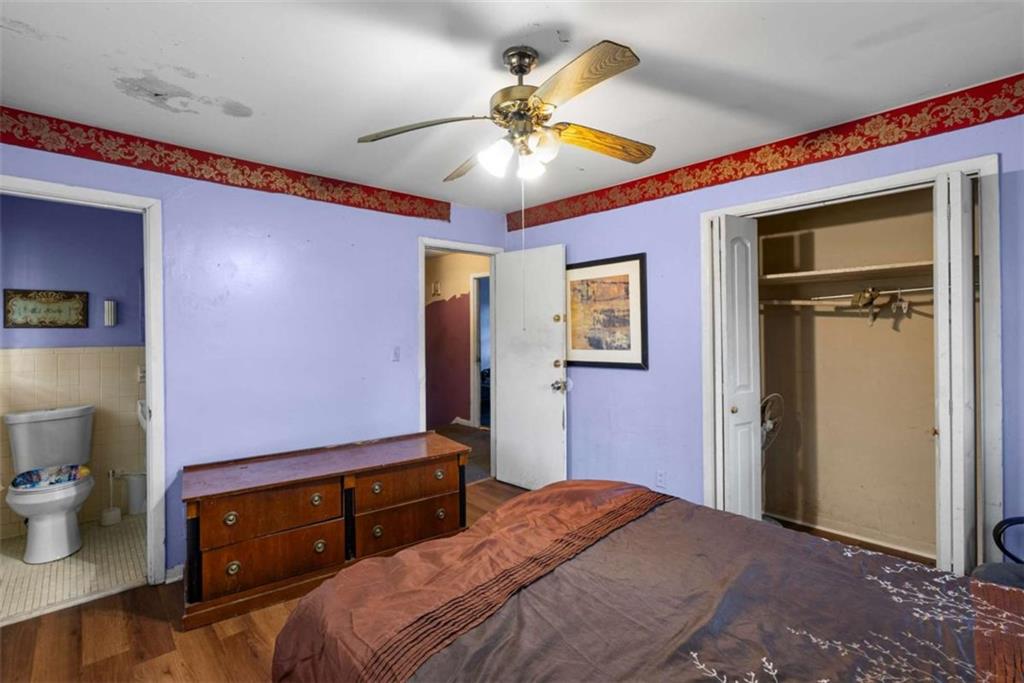 2390 Mellville Avenue Decatur, GA 30032 - Photo 18 of 26 a bedroom with a bed and a chandelier