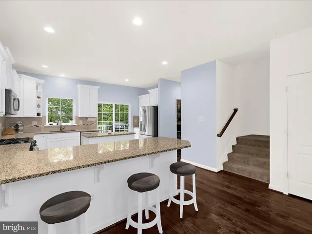 a kitchen with wooden floors and sink
