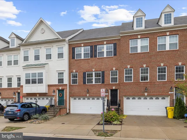 a front view of a residential apartment building with a yard