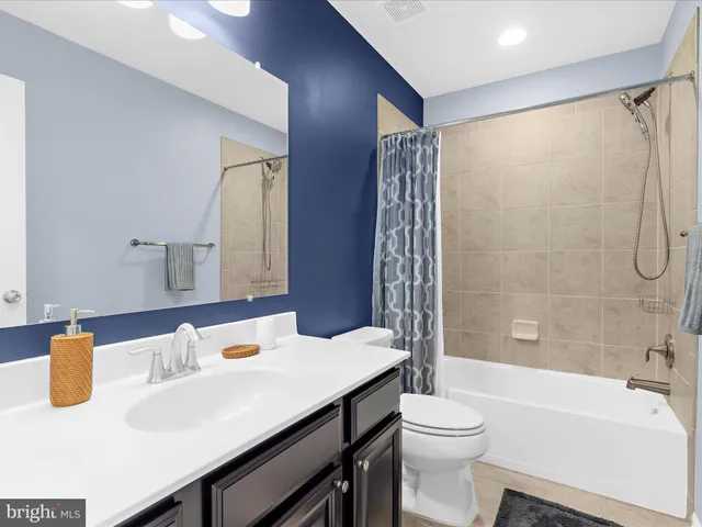 a bathroom with a shower curtain and a sink