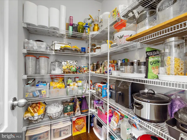 a living room with a couch and a wooden floor