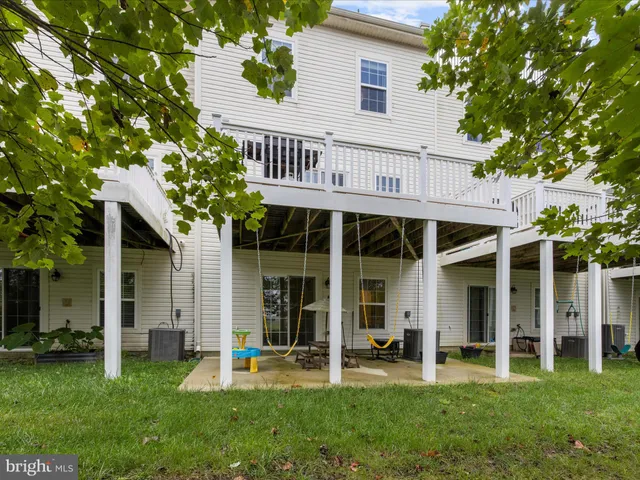 a living room with patio furniture and a fireplace