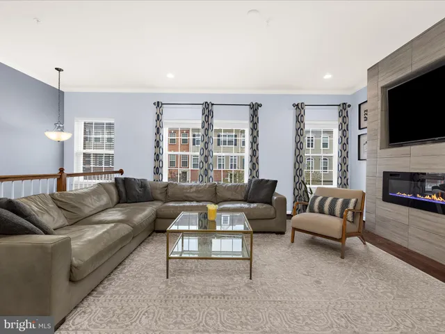 a living room with furniture fireplace and flat screen tv