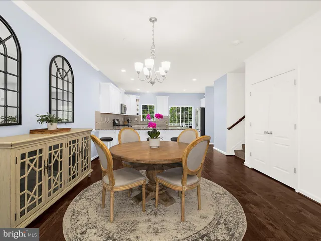 a view of a a dining room with furniture window and wooden floor