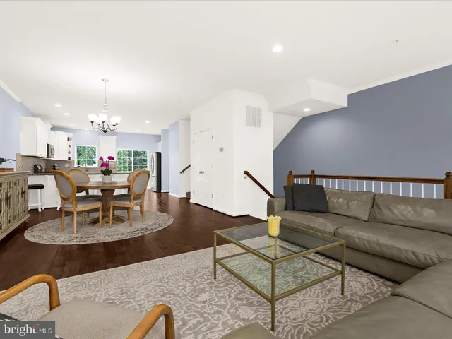 a living room with furniture kitchen view and a dining table