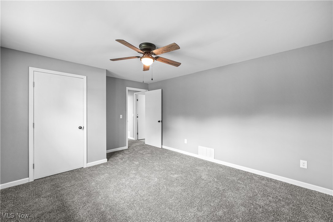23595 Sandy Creek Road Minerva, OH 44657 - Photo 13 of 32 Unfurnished bedroom featuring baseboards, carpet, and ceiling fan
