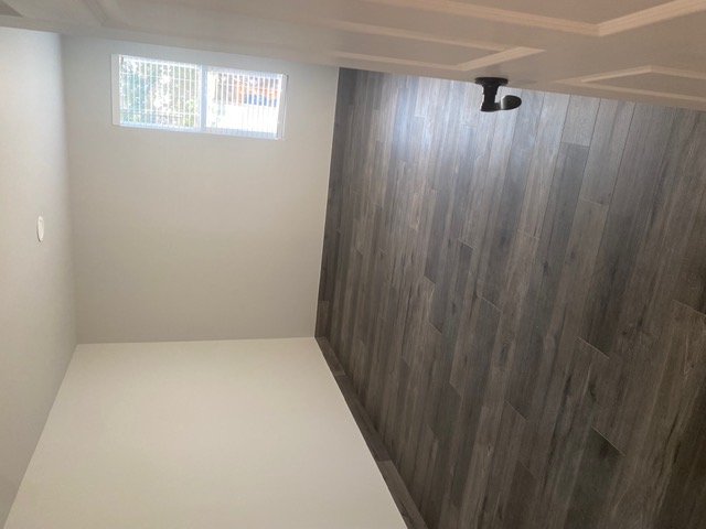 183 Mimosa Road Dale, TX 78616 - Photo 7 of 11 Room featuring wood-look tile flooring, white walls, and a recessed ceiling light
