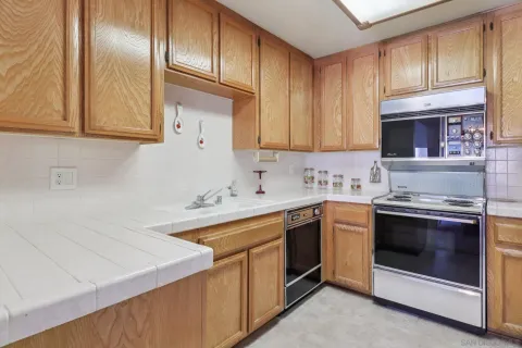 a kitchen with a sink stove and cabinets
