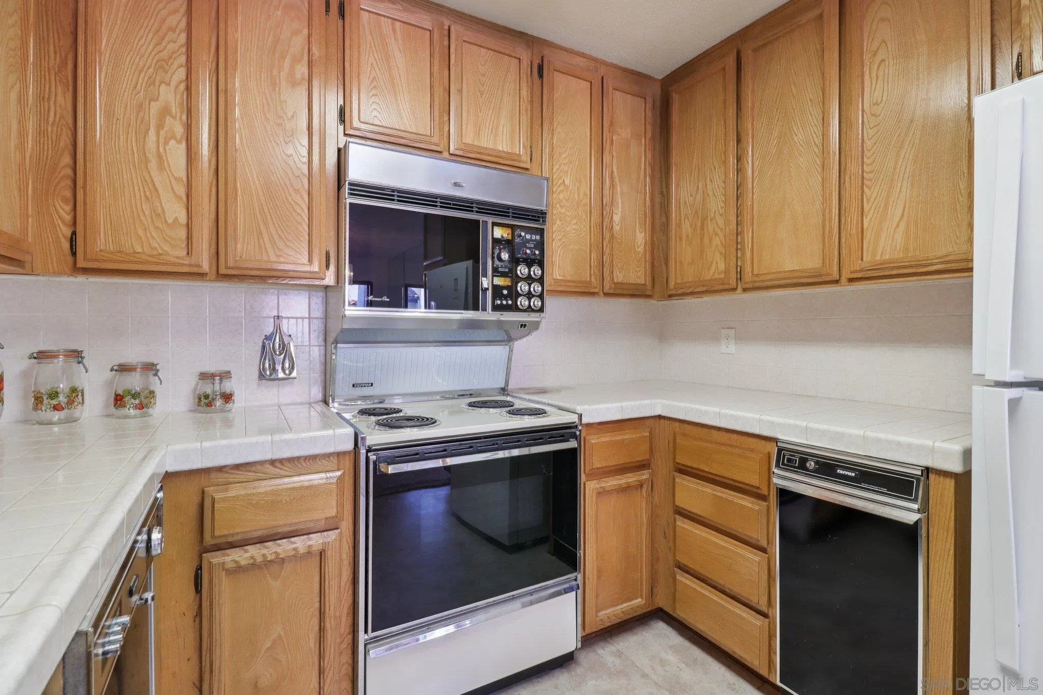 5645 Friars Road, Unit 386 San Diego, CA 92110 - Photo 12 of 45 a kitchen with a sink stove and cabinets