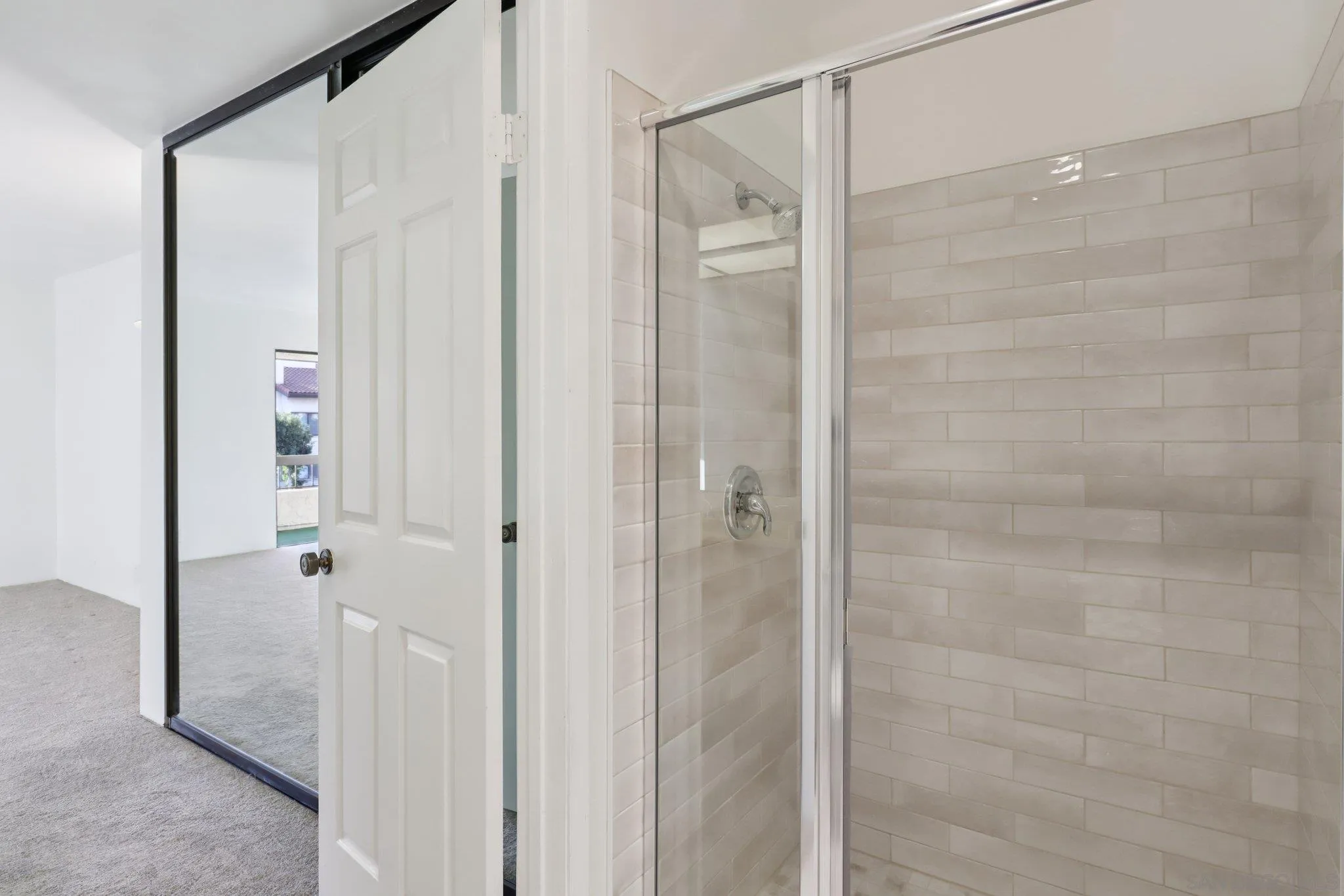 5645 Friars Road, Unit 386 San Diego, CA 92110 - Photo 20 of 45 a bathroom with a glass shower door