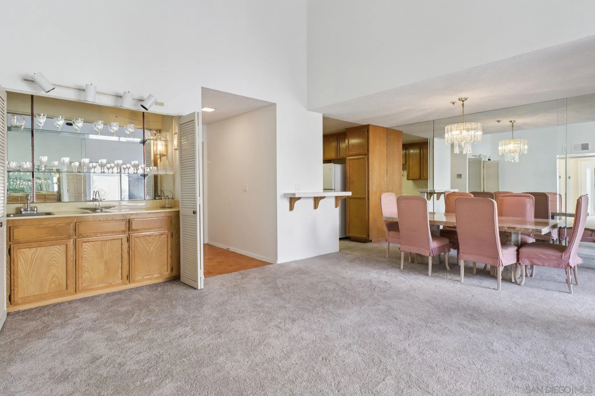 5645 Friars Road, Unit 386 San Diego, CA 92110 - Photo 2 of 45 a large white kitchen with a table and chairs