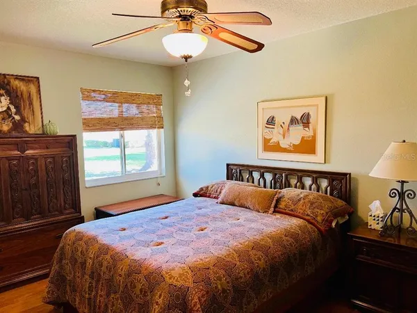 a bed sitting in a bedroom next to a window