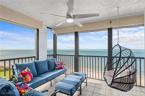 a bedroom with furniture and a large window
