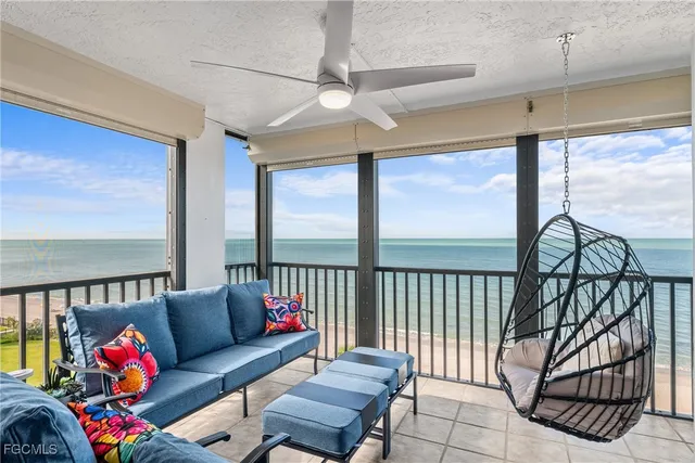 a bedroom with furniture and a large window