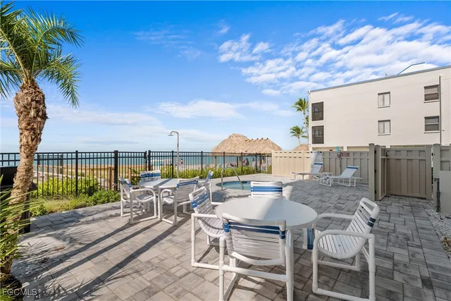 a swimming pool with outdoor seating and yard