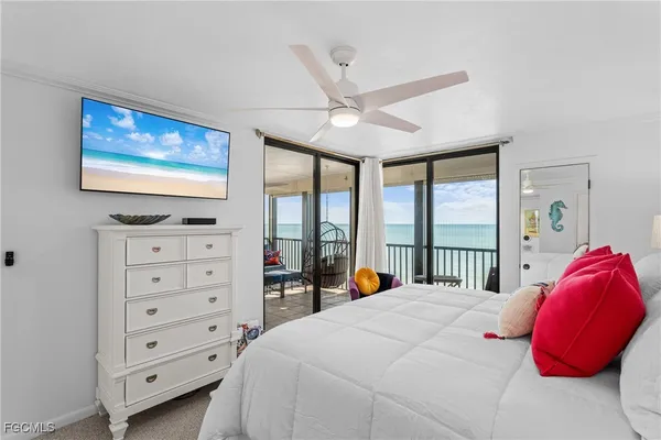 a bedroom with a bed and a flat tv screen