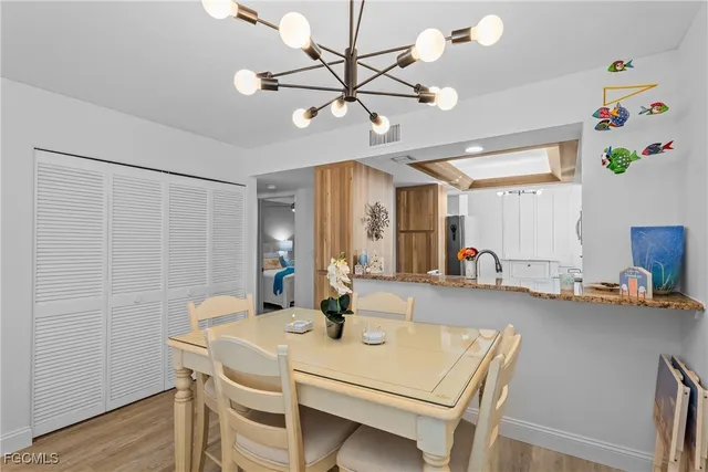 a view of a dining room with furniture and a chandelier fan