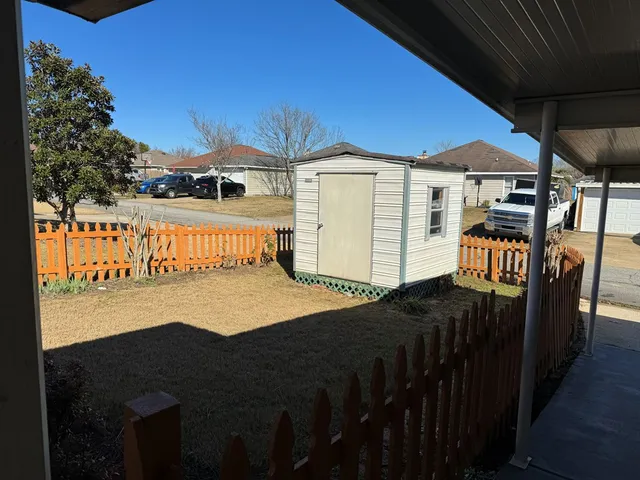 a view of a house with backyard and deck