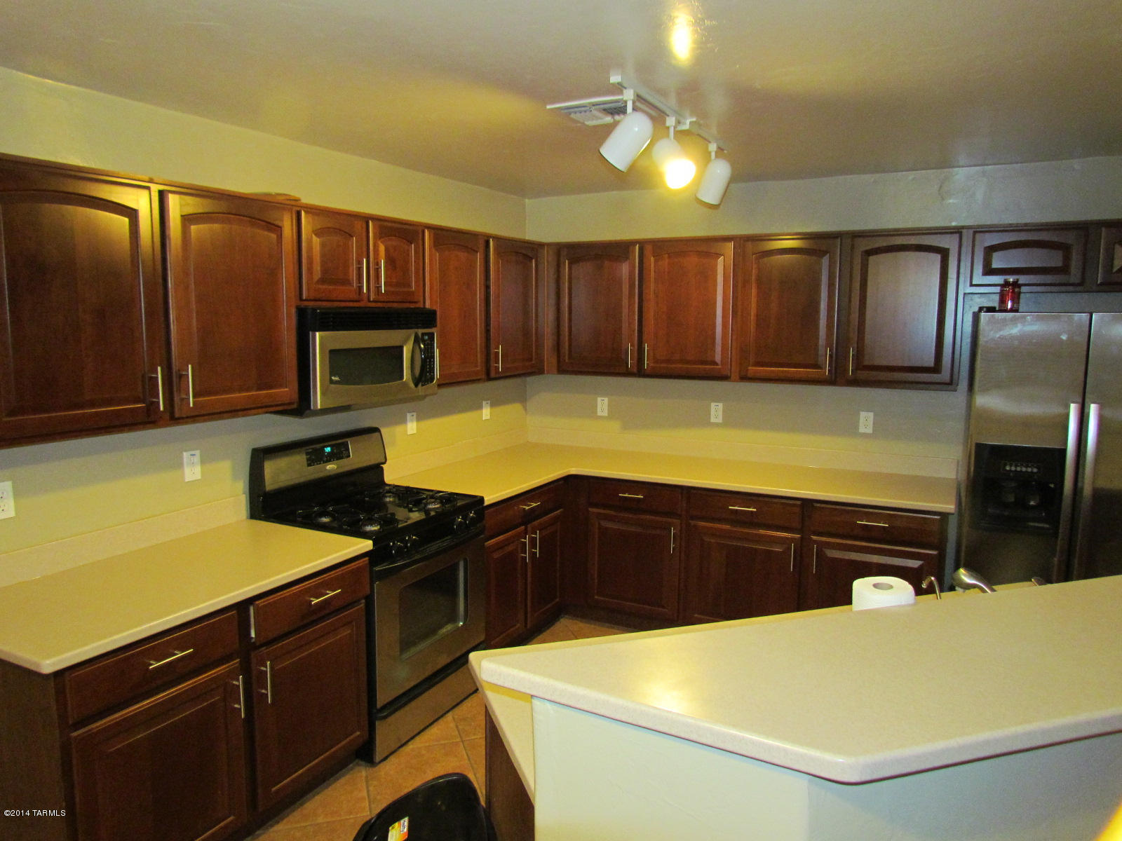 669 West Ash Ridge Drive Green Valley, AZ 85614 - Photo 3 of 17 a kitchen with stainless steel appliances a stove microwave and refrigerator