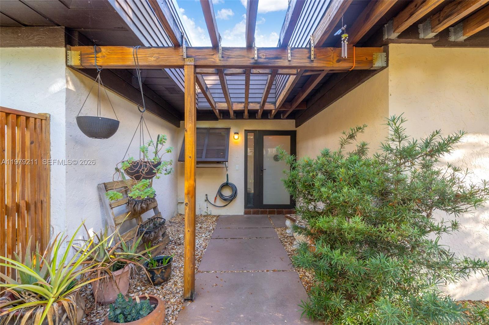 3785 Raleigh Street Hollywood, FL 33021 - Photo 1 of 36 a view of a porch with a table and chairs