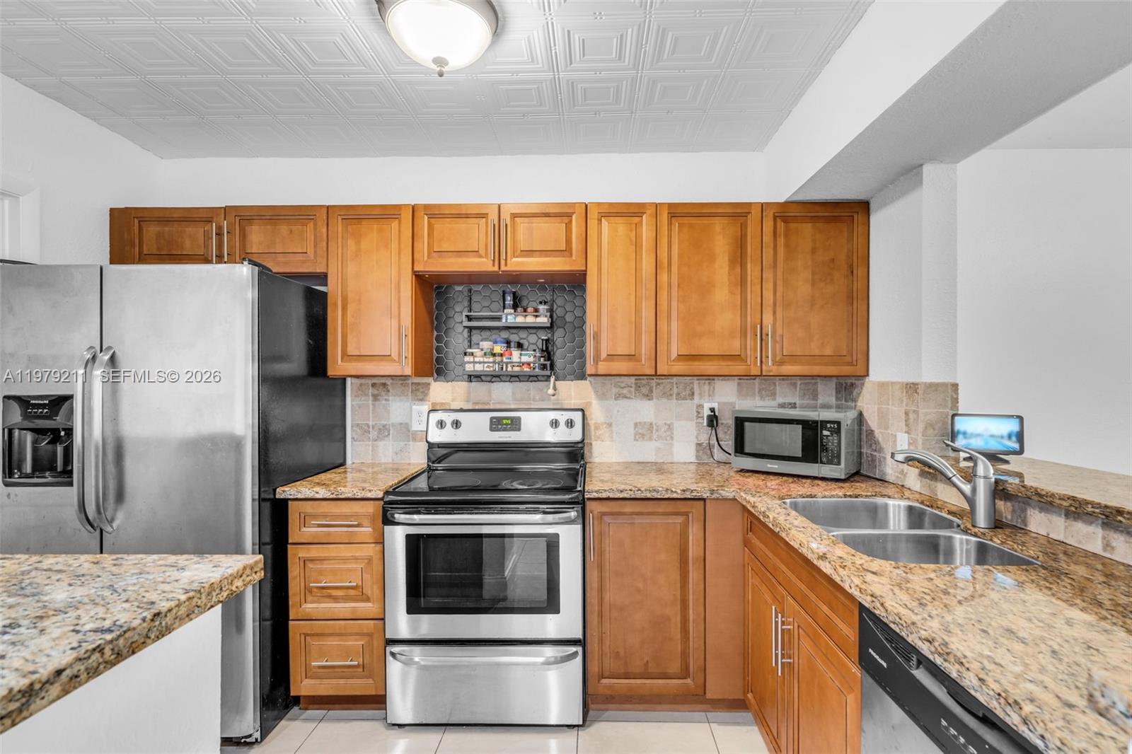 3785 Raleigh Street Hollywood, FL 33021 - Photo 12 of 36 a kitchen with a sink stove and refrigerator